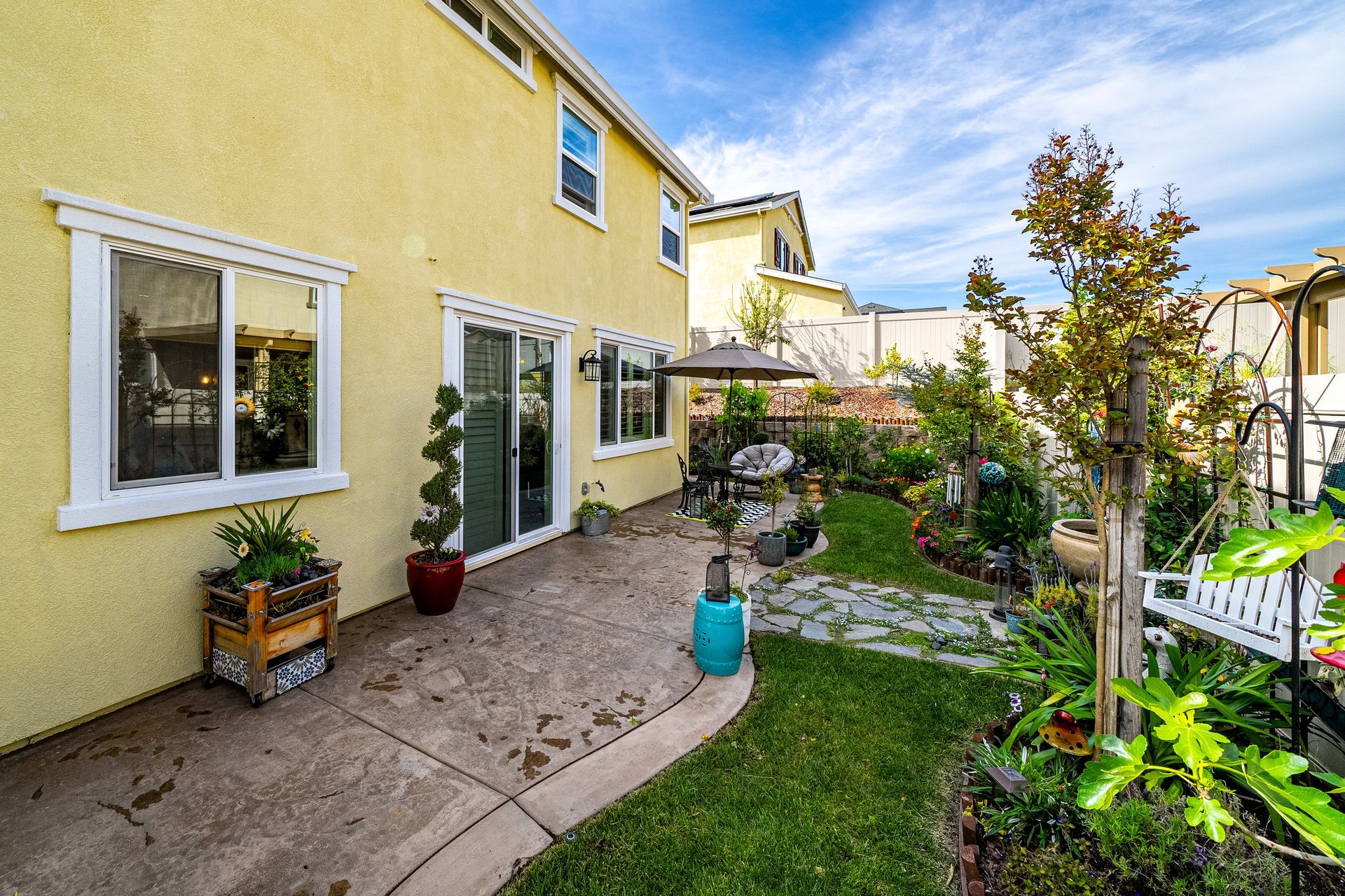 Side yard with green lawn and walkway, listed by a top real estate agent from Nicole Spencer—GUIDE Real Estate.