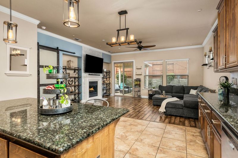 Kitchen on La Guardia Circle with granite island and sliding glass door to the living room.