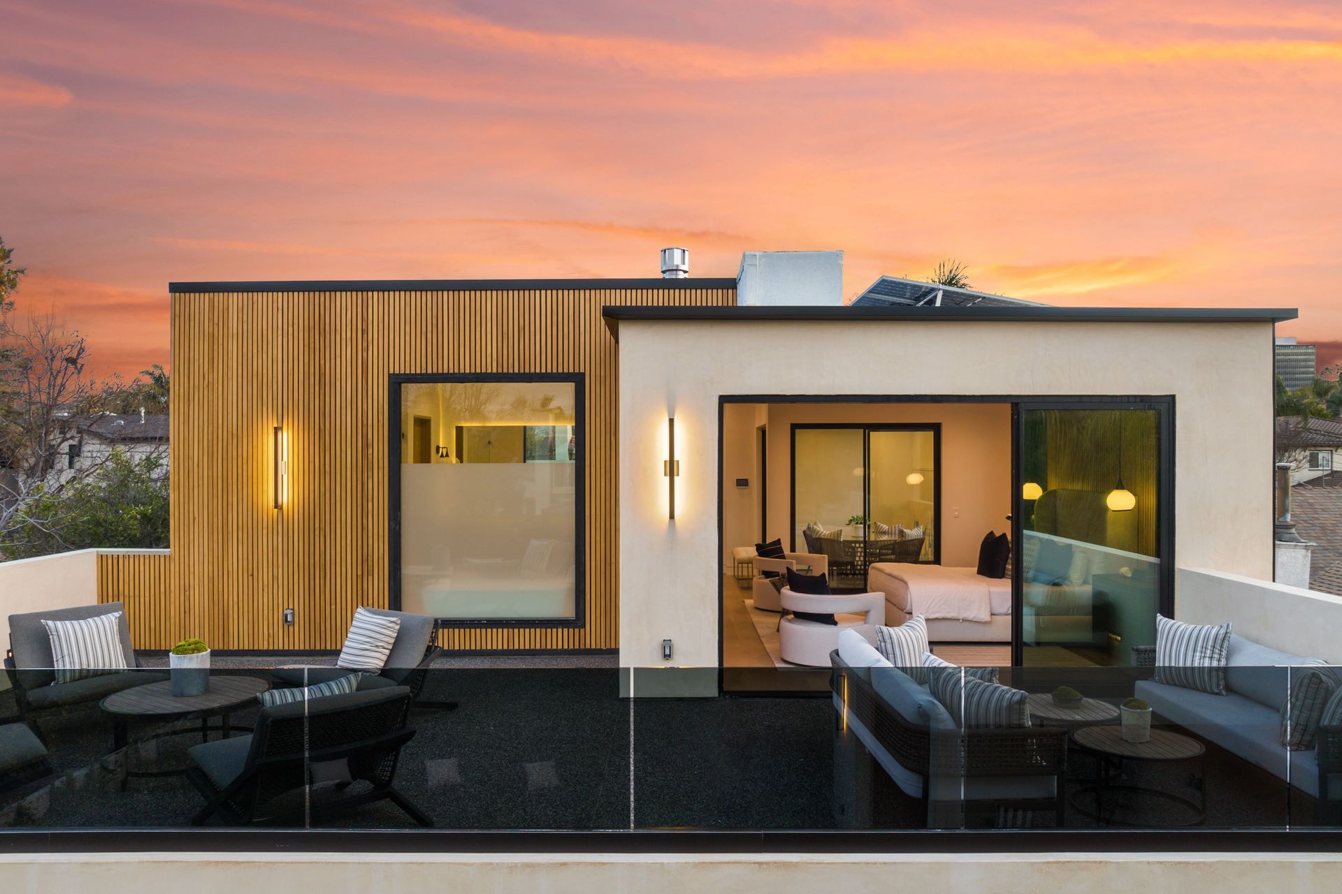 Contemporary single-story home at dusk with warm interior lighting and minimalist exterior.
