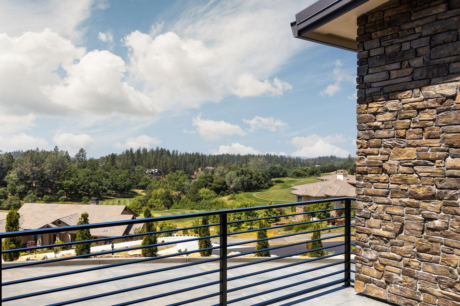 There is a balcony with a view of the mountains and trees | Homes for Sale