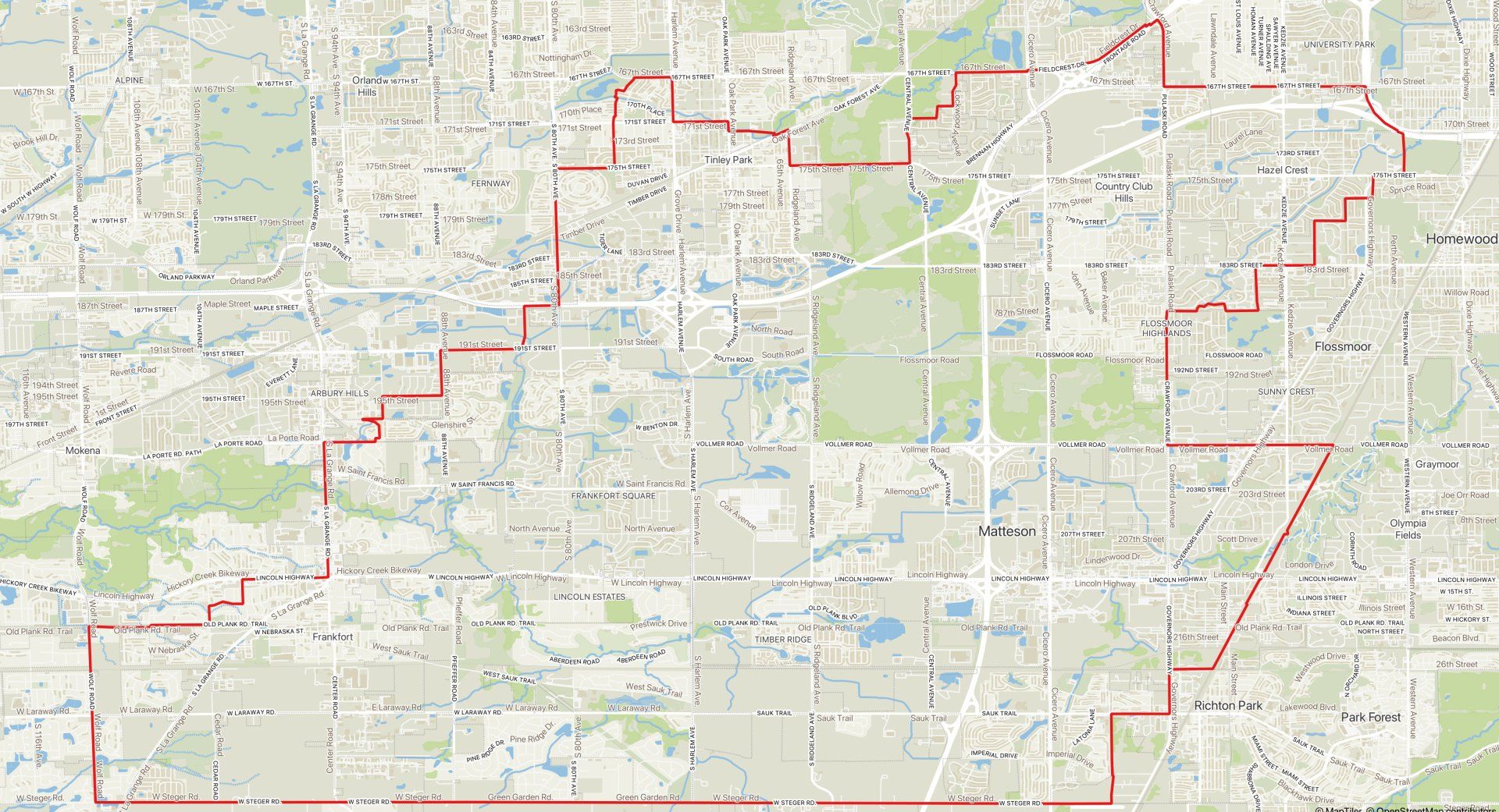 Map with a red boundary outline over city streets and green park areas