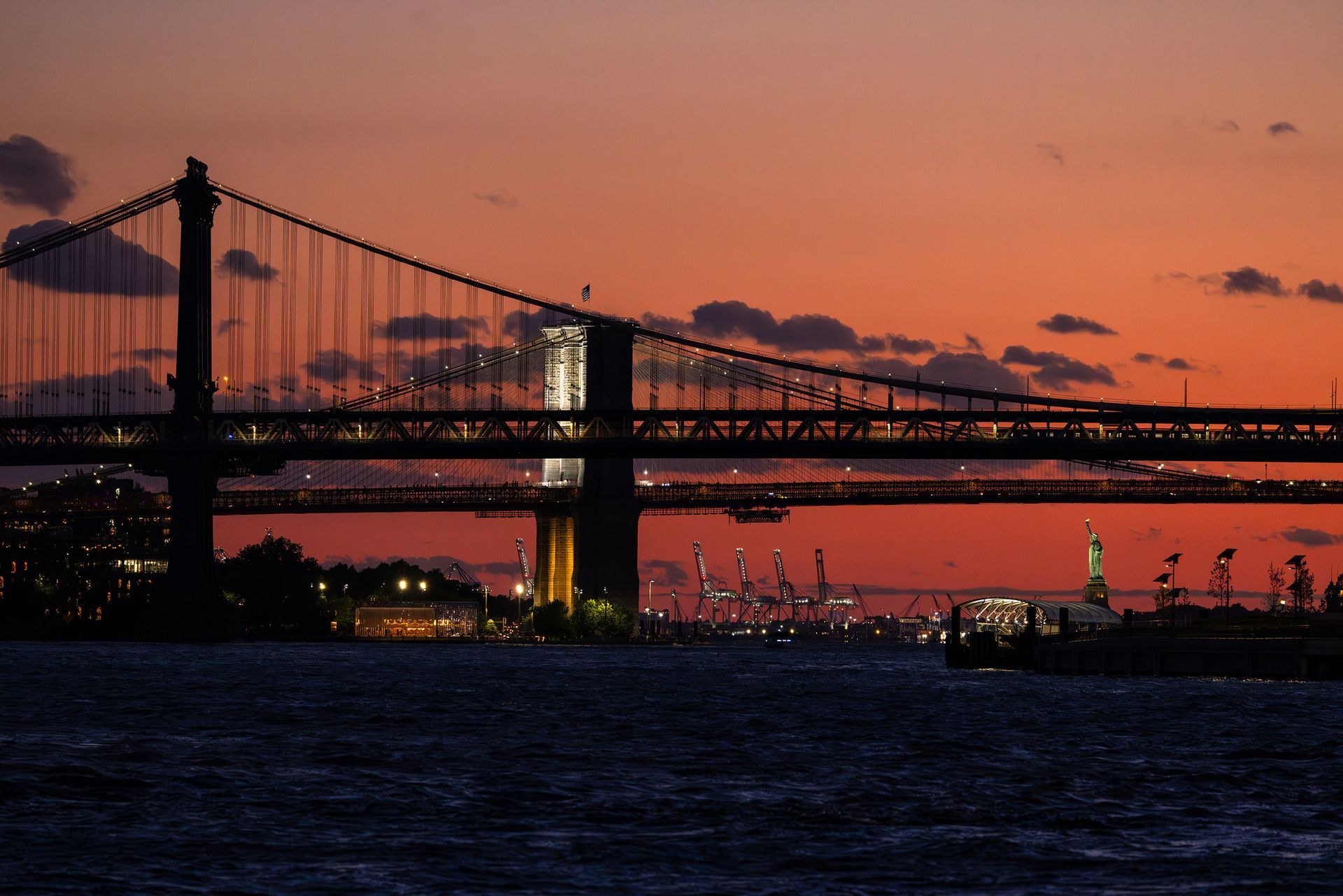 Sunset view from Domino Park in Brooklyn, Brooklyn Bridge Statue of Liberty