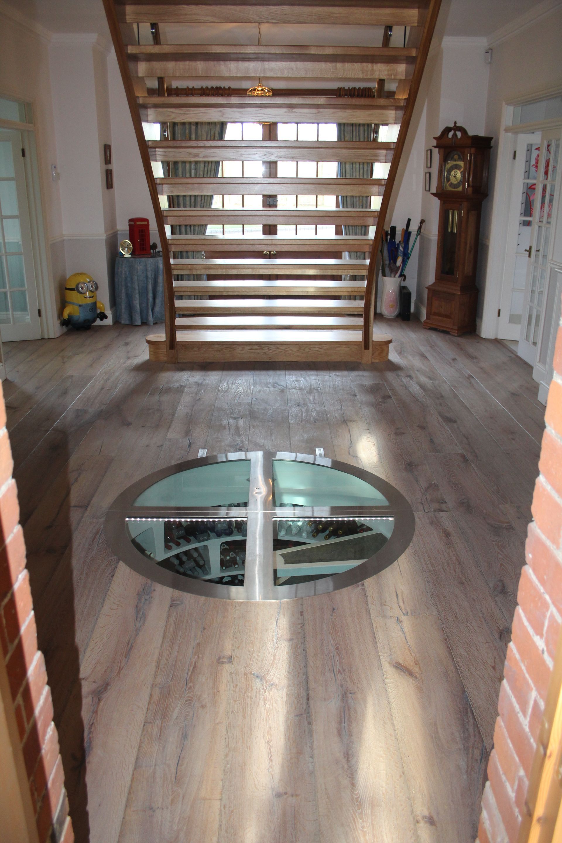 Wine cellar under staircase at Great Easton Residence fitted with Mock Reclaimed Oiled Oak