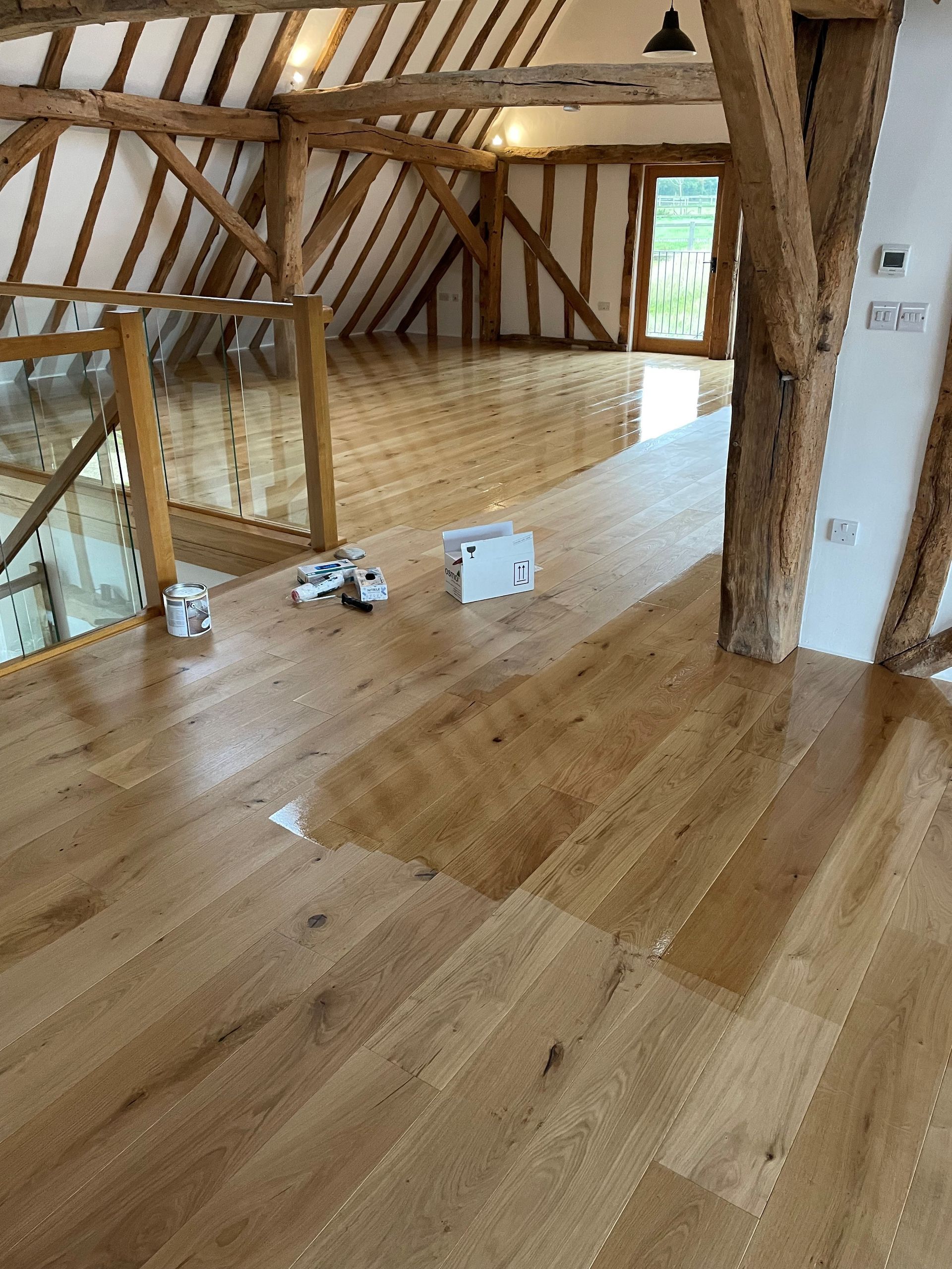 Dyfed Richards employee halfway through oiling a fitted floor