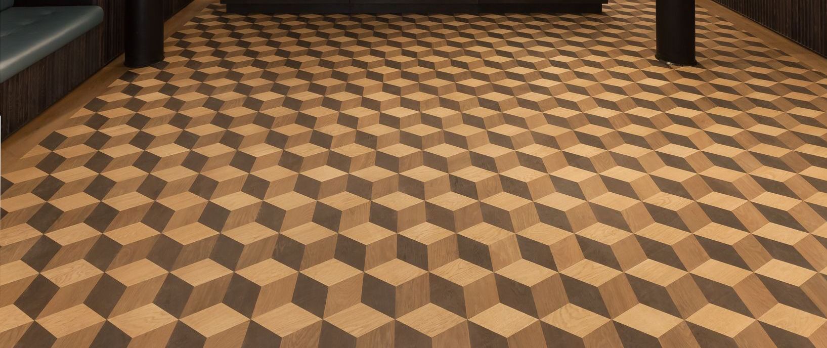 Wooden floor with a repeating 3D cube pattern.