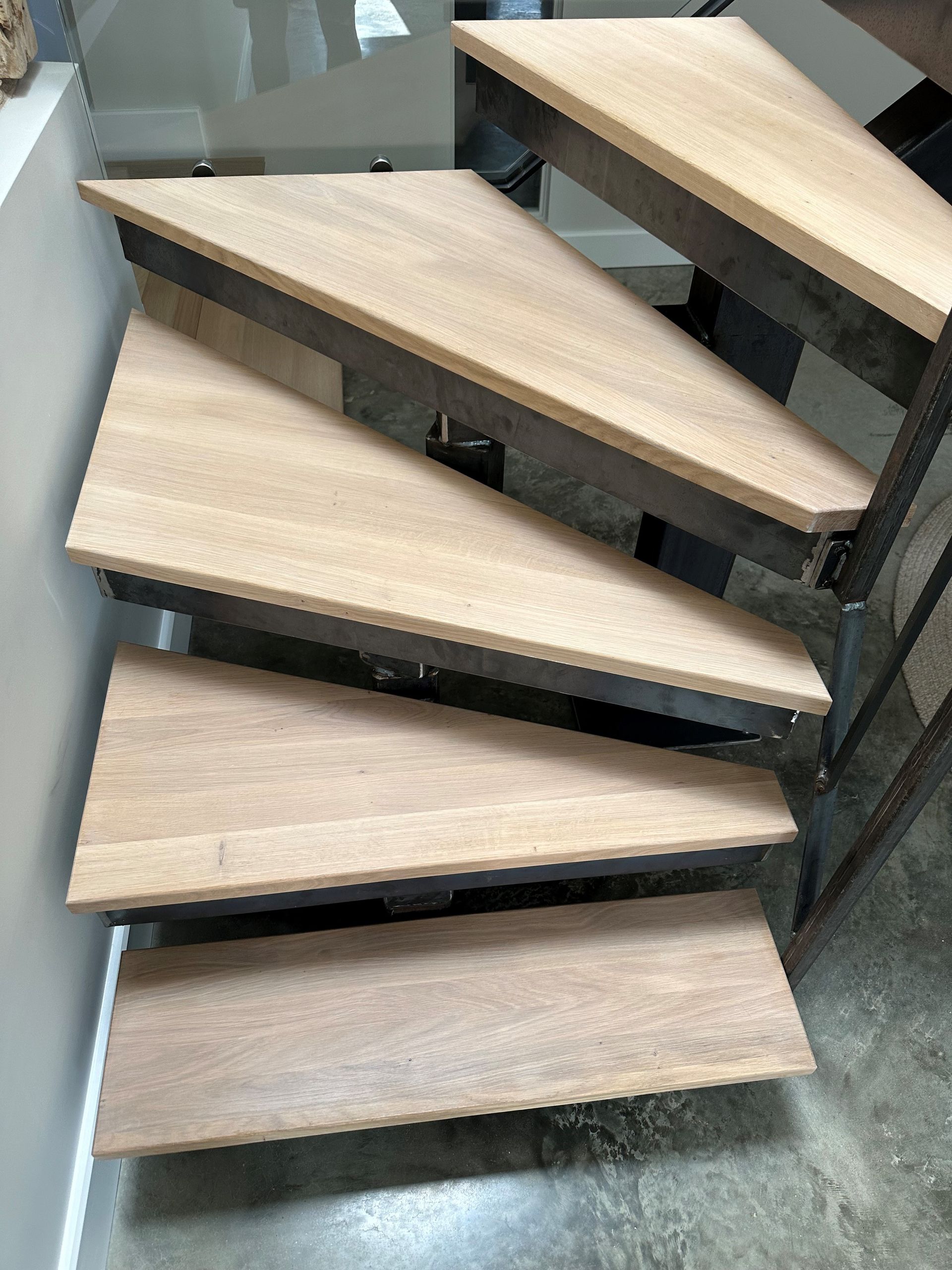 A close up of a wooden staircase with a metal frame.