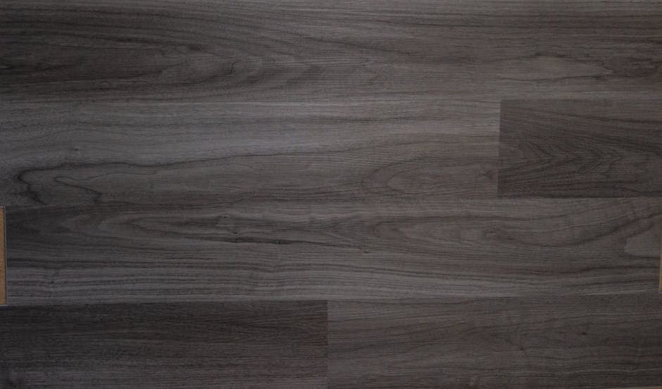 Dark gray wood-look flooring with wood grain pattern, horizontal planks.