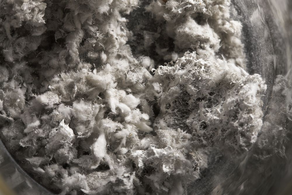 Gray, Fluffy Material, Possibly Insulation, Filling a Container — Brucic Construction in Goulburn, NSW