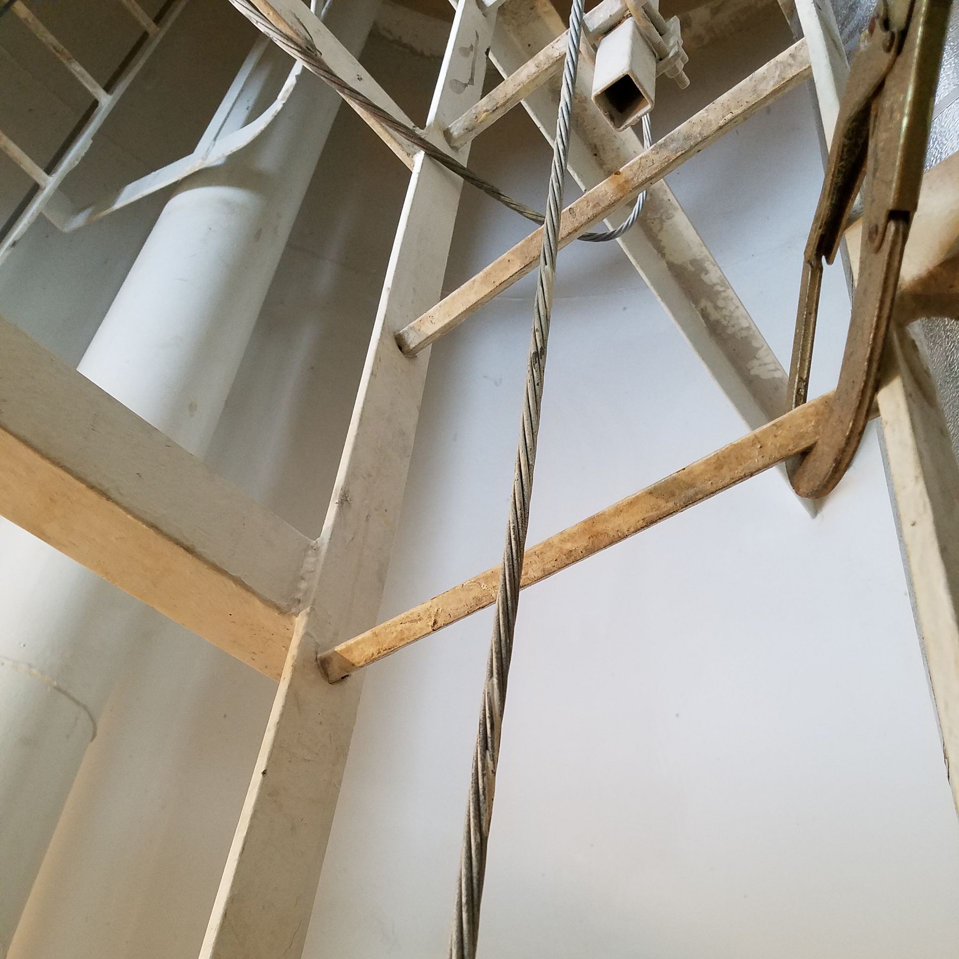 Looking up at a ladder with a rope attached to it