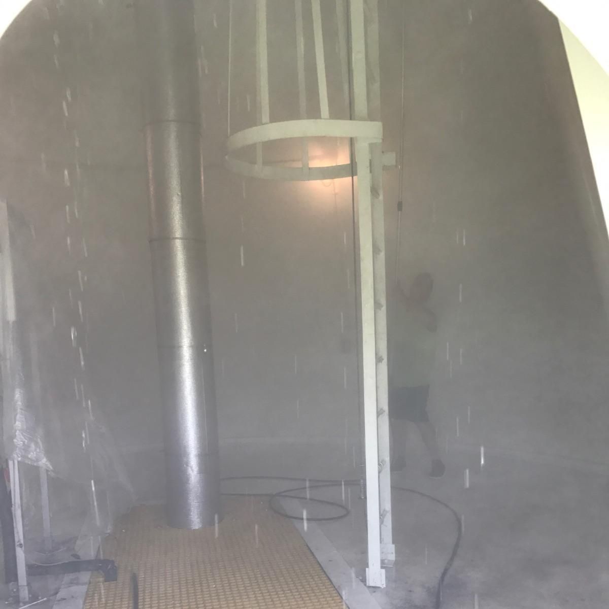 A person is standing in a room with a ladder.