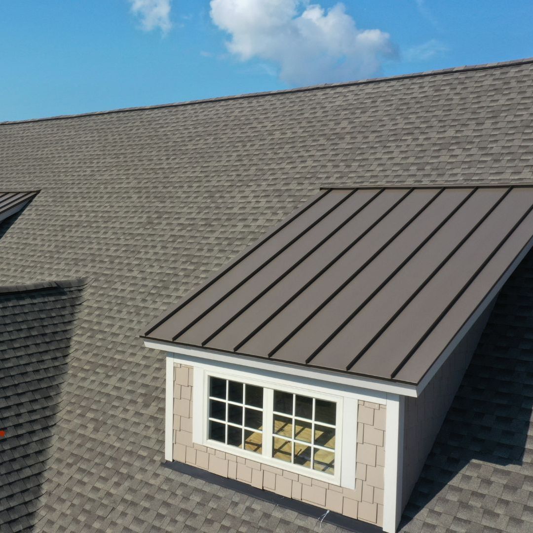 A house with a roof that has a window on it