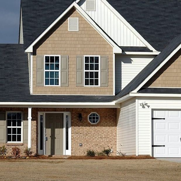 The front of a house with a white garage door