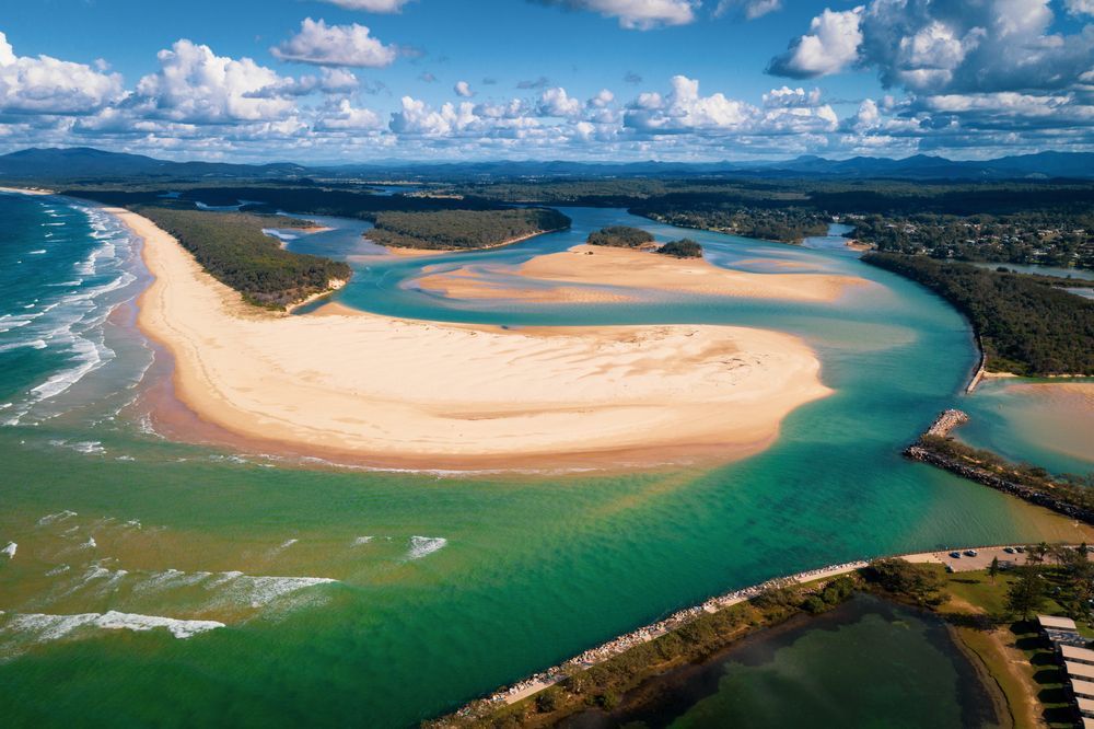 An Aerial View of a River Flowing Through a Sandy Beach — Able Building And Pest Inspections In Nambucca Heads, NSW