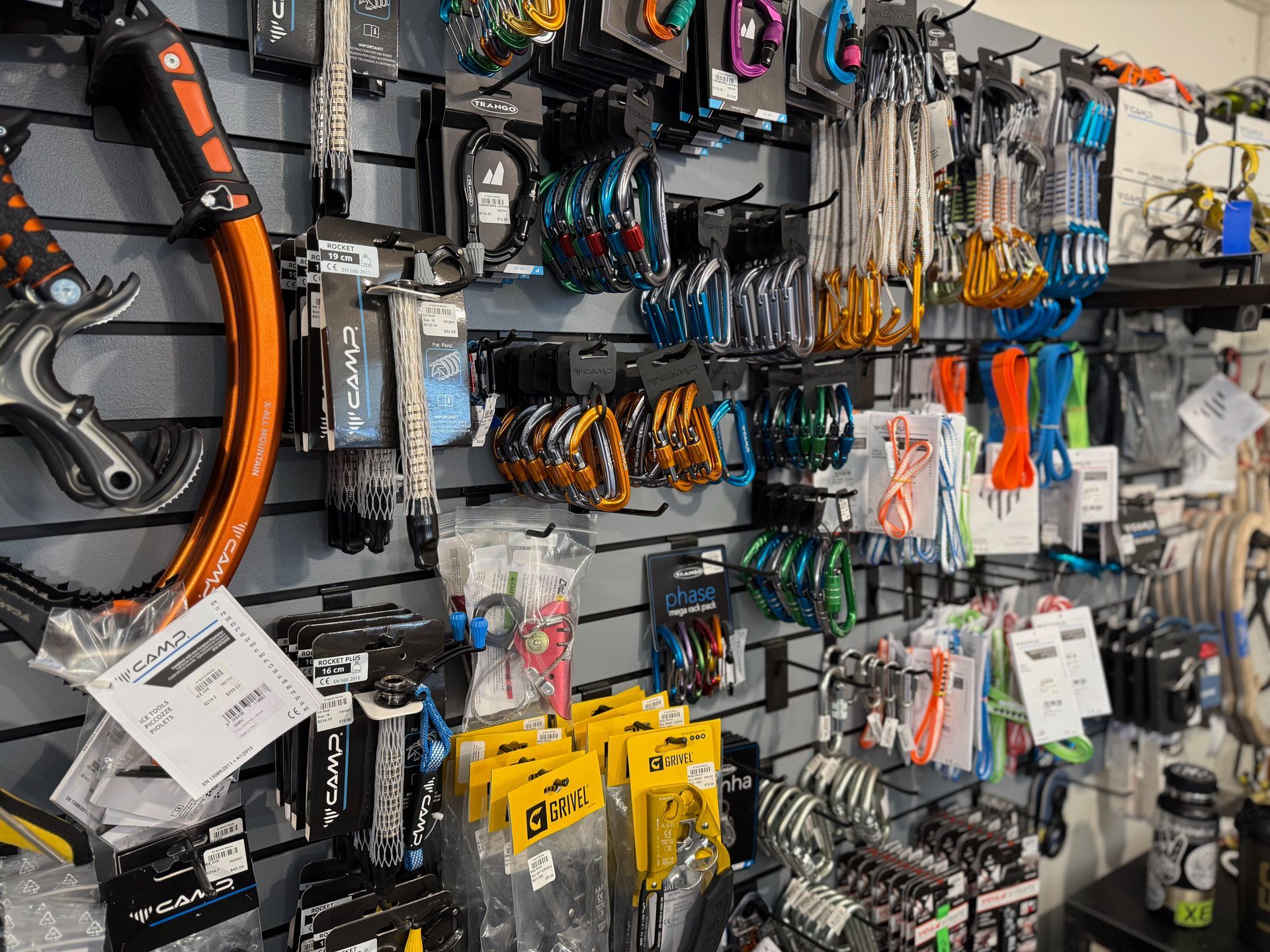 A wall filled with lots of different types of climbing equipment.