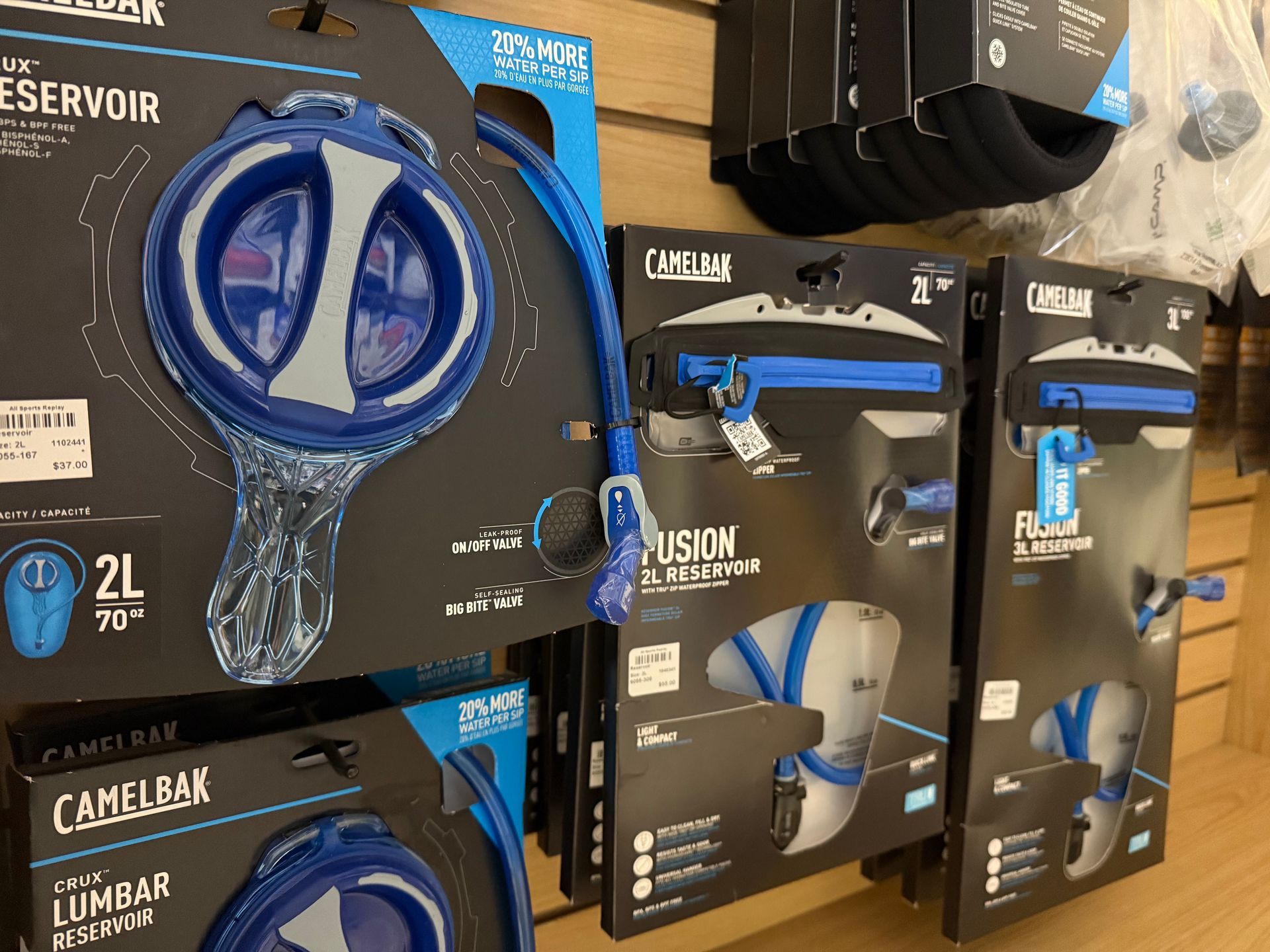 A bunch of skis are hanging on a rack in a store.