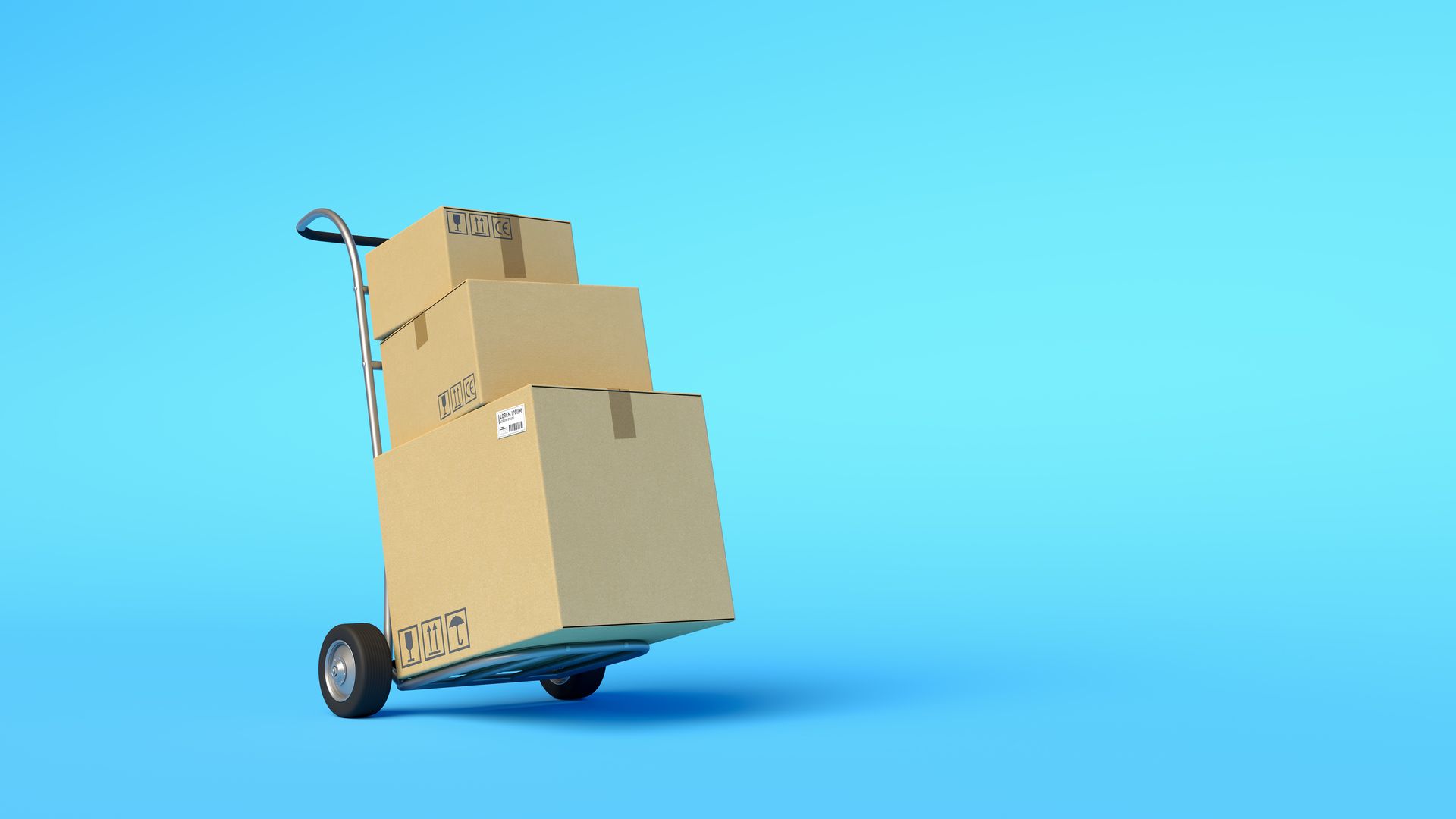 Boxes stacked on a cart outside a warehouse dock for commercial loading services Boxes stacked on a cart outside a warehouse dock for commercial loading services