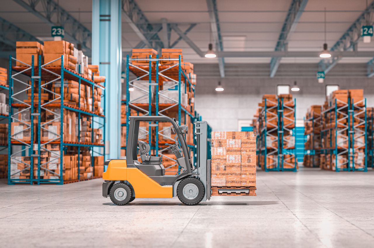 Yellow forklift in a warehouse aisle with stacked boxes on tall blue shelving.
