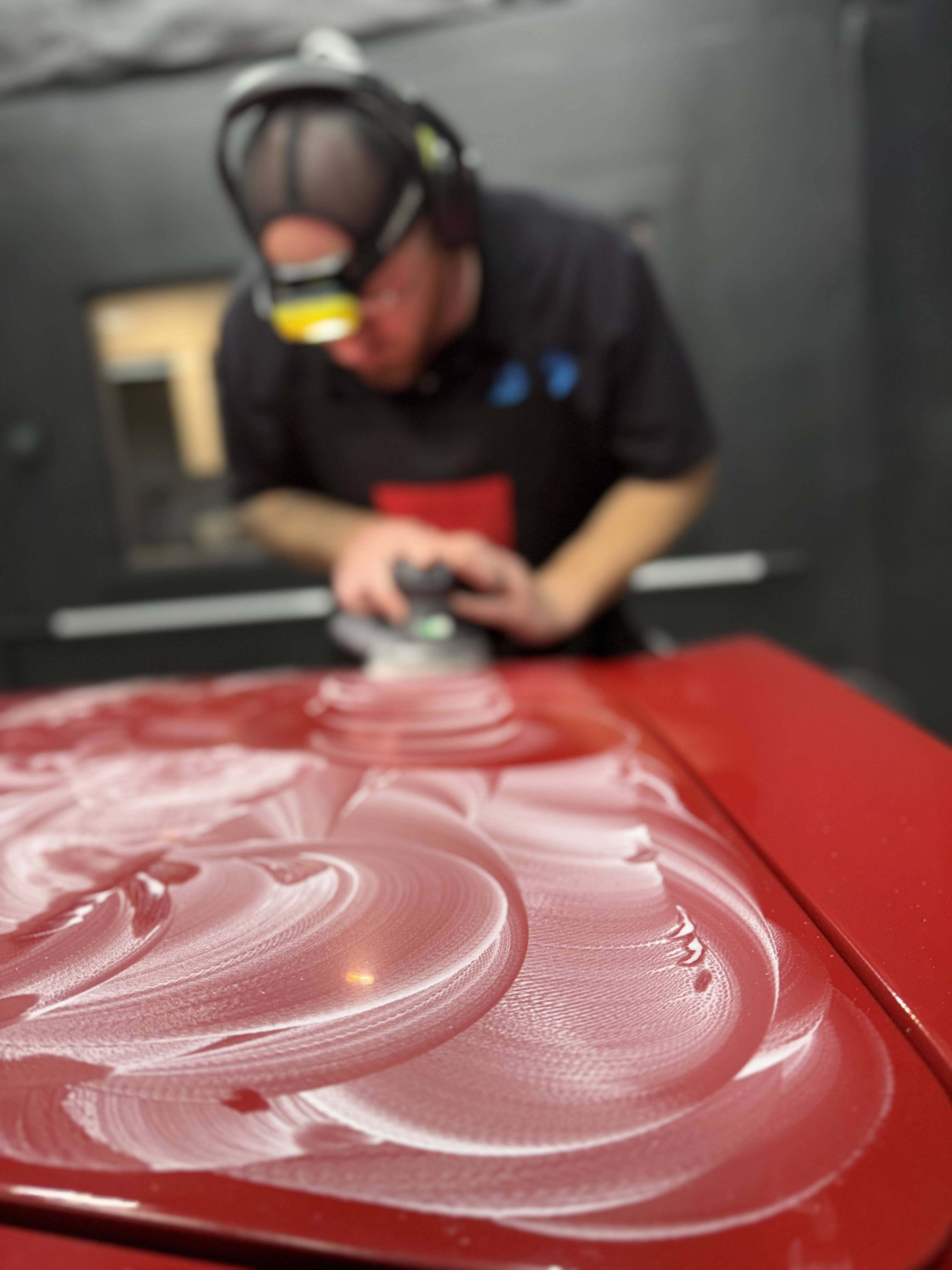 A man is applying window tinting to a car door