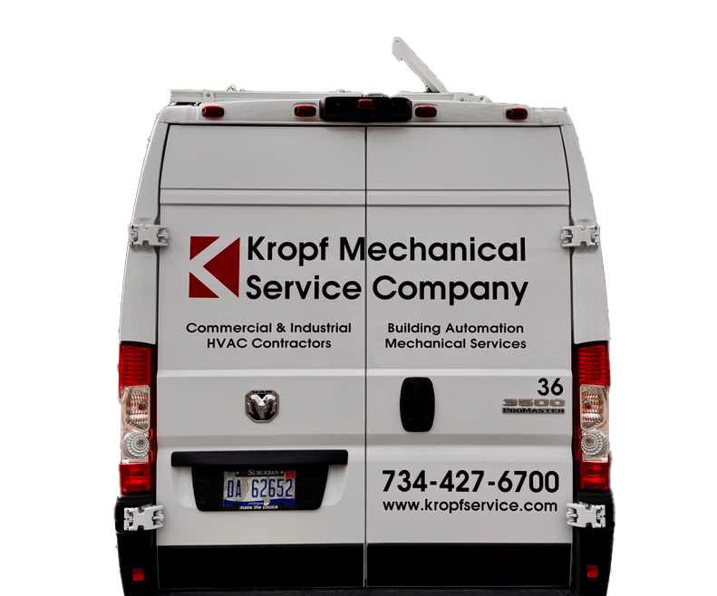 The back of a white van that says kropf mechanical service company