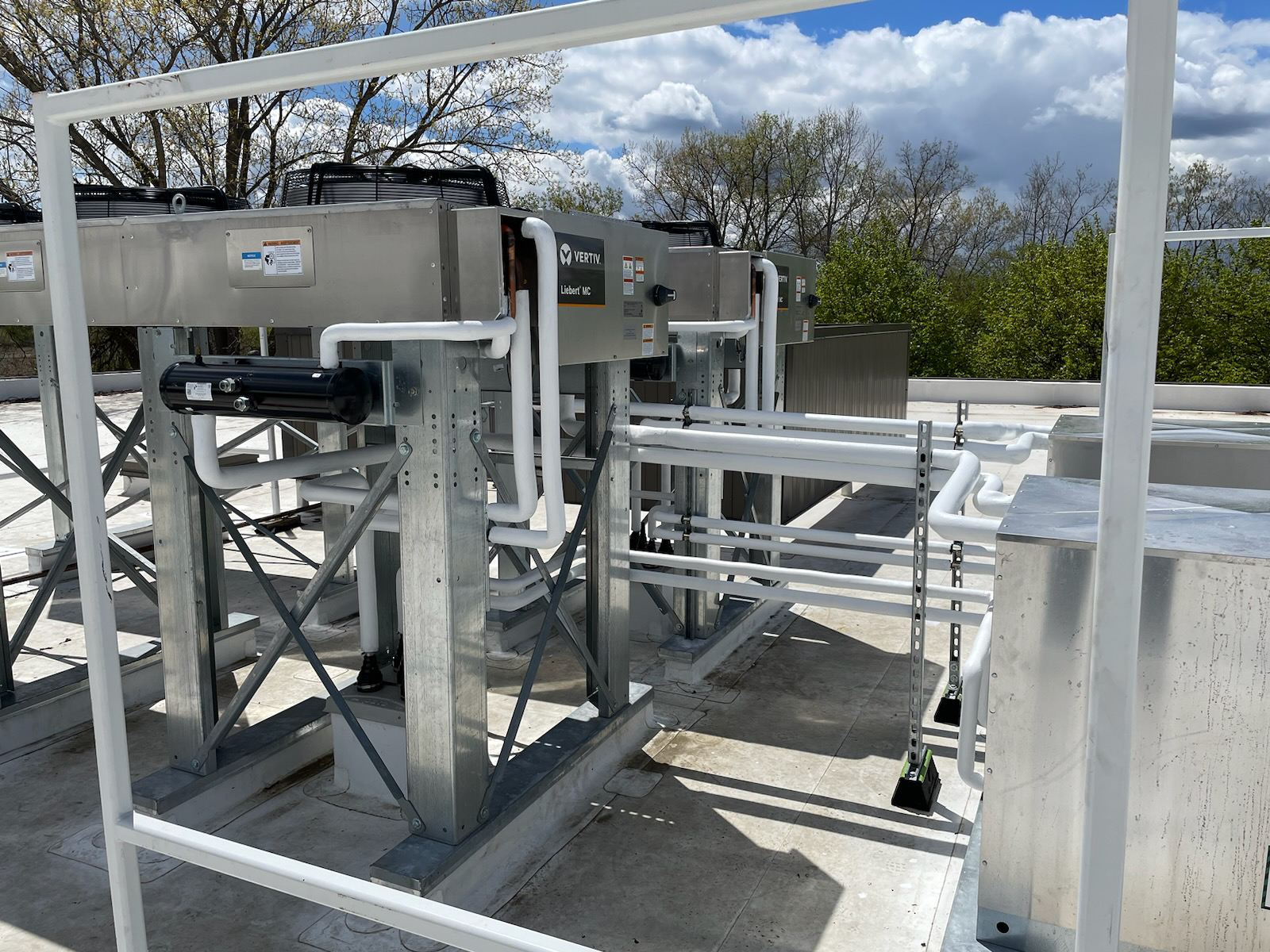 A rooftop with a lot of pipes and machinery on it.