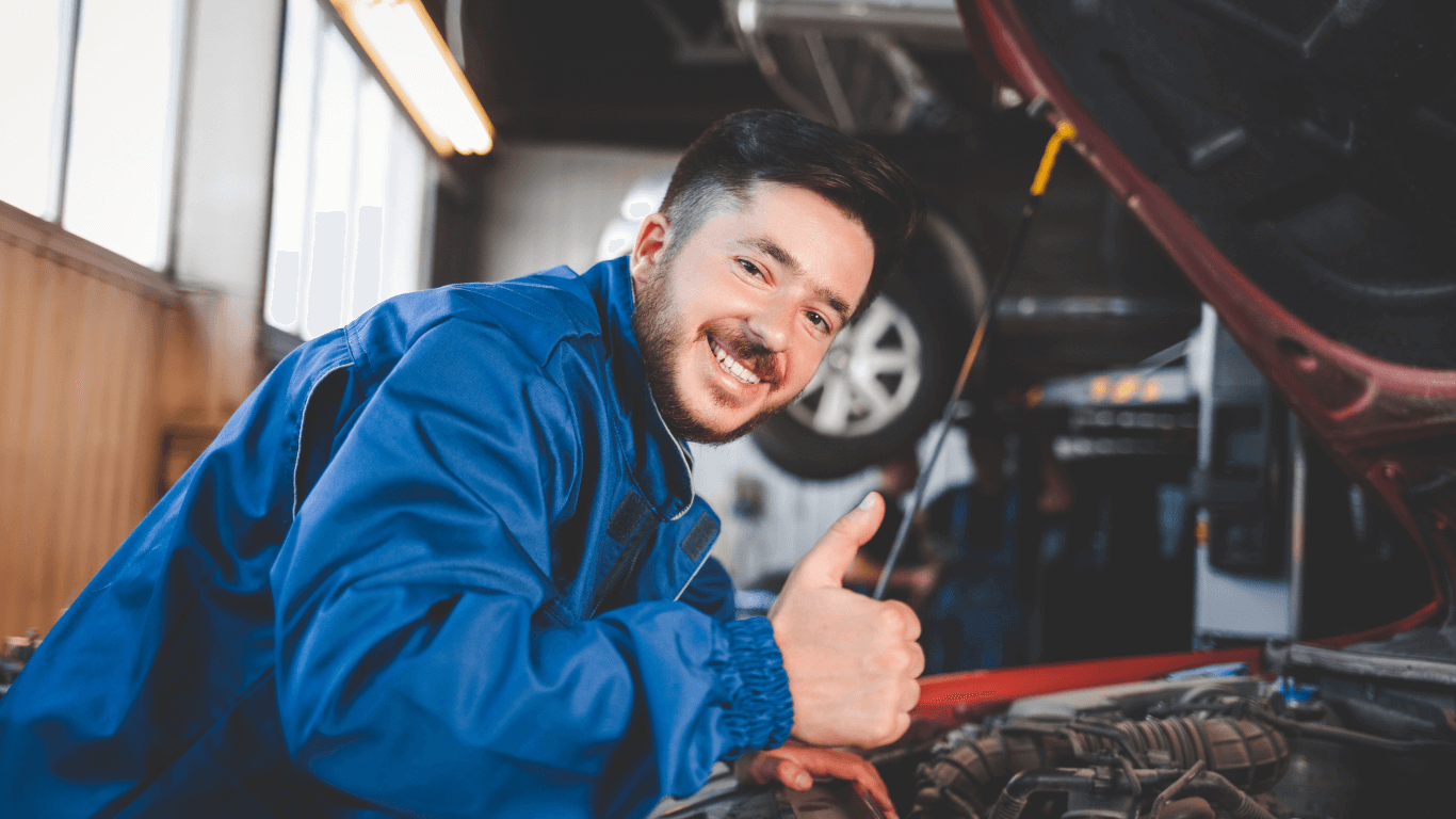 happy man doing auto repair