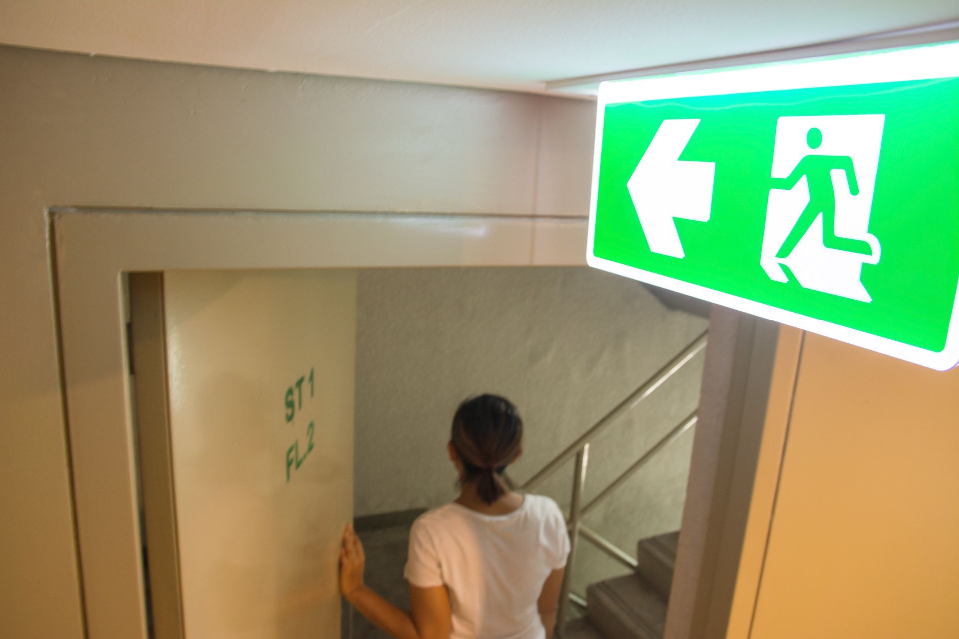 Emergency lighting inverter lighting an emergency exit sign.