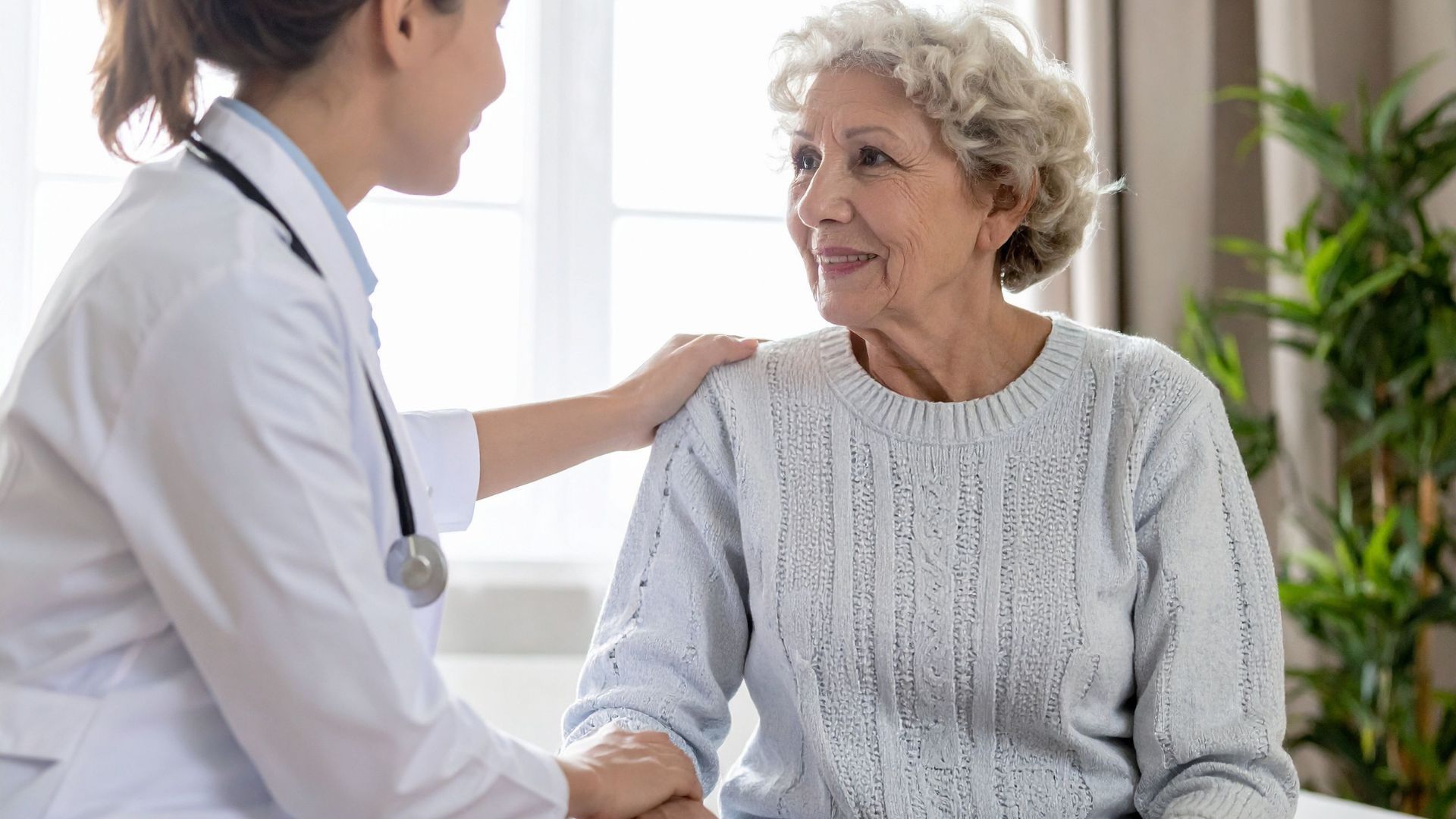 Doctor speaking with a smiling patient in a bright clinic room