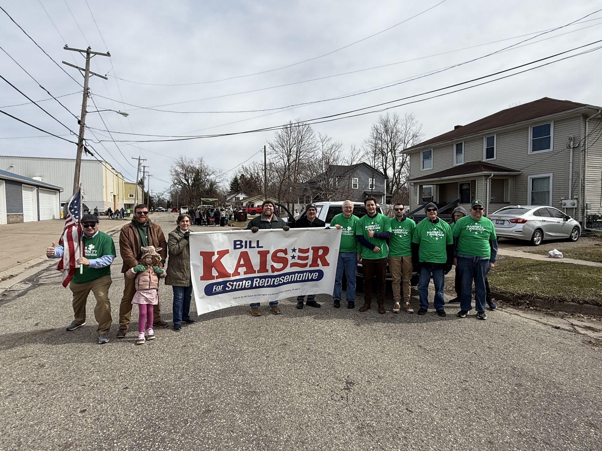 Campaign group holding a “Bill Kaiser” banner on a residential street.