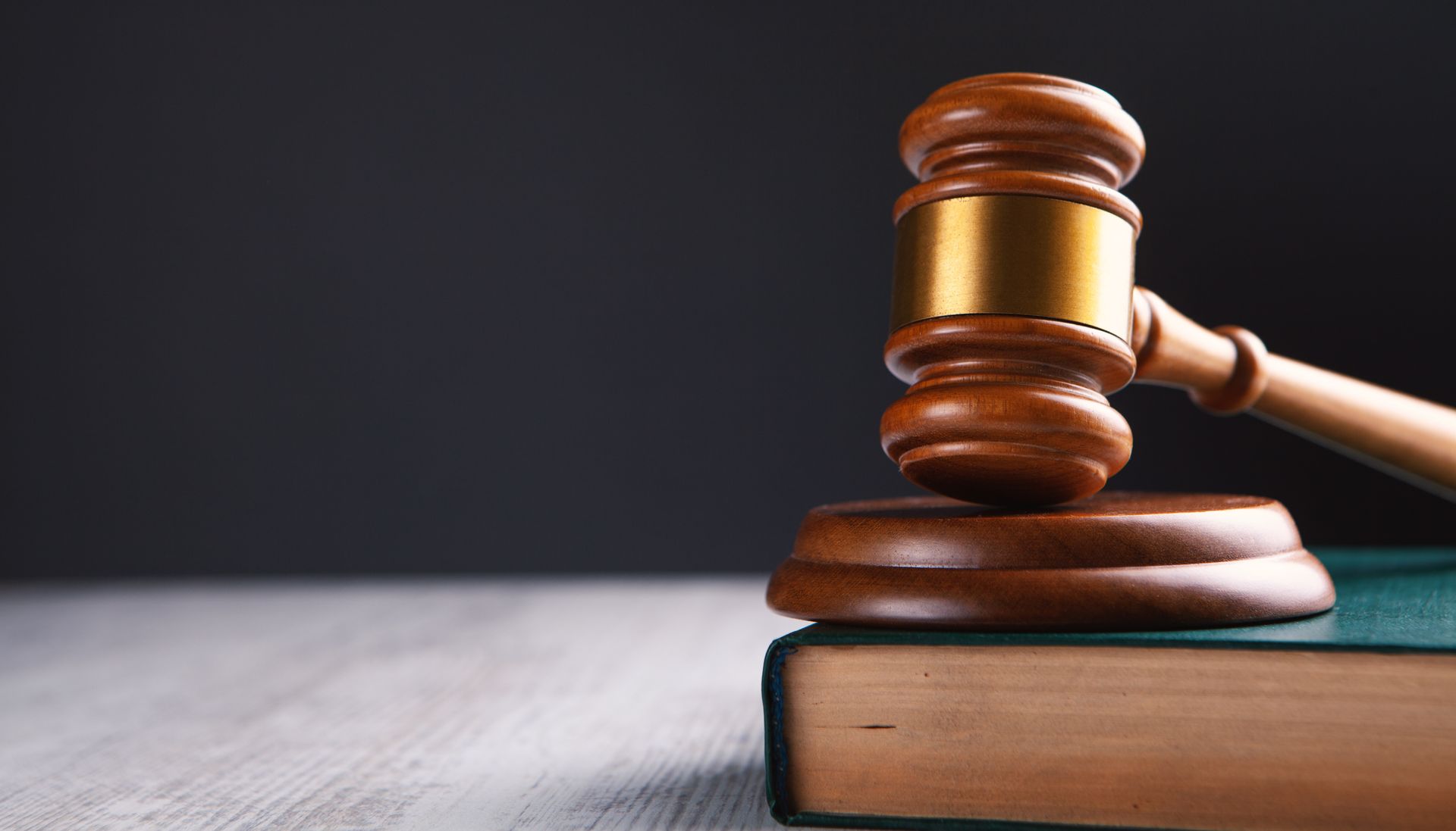 Judge's gavel resting on a law book, symbolizing justice and legal authority Judge's gavel resting on a law book, symbolizing justice and legal authority