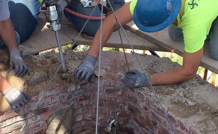 Cenaxo masons dismantling deteriorated stonework at Grace Episcopal Church — steeple restoration by H.H. Richardson-designed church, New Bedford MA