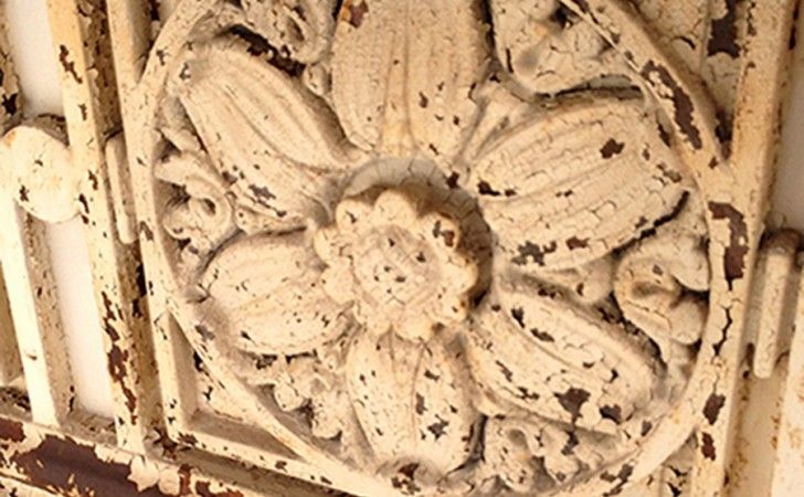 Cast iron rosette before restoration — 90+ years of lead-based paint buildup at Travelers Tower, Hartford CT — restored by Cenaxo