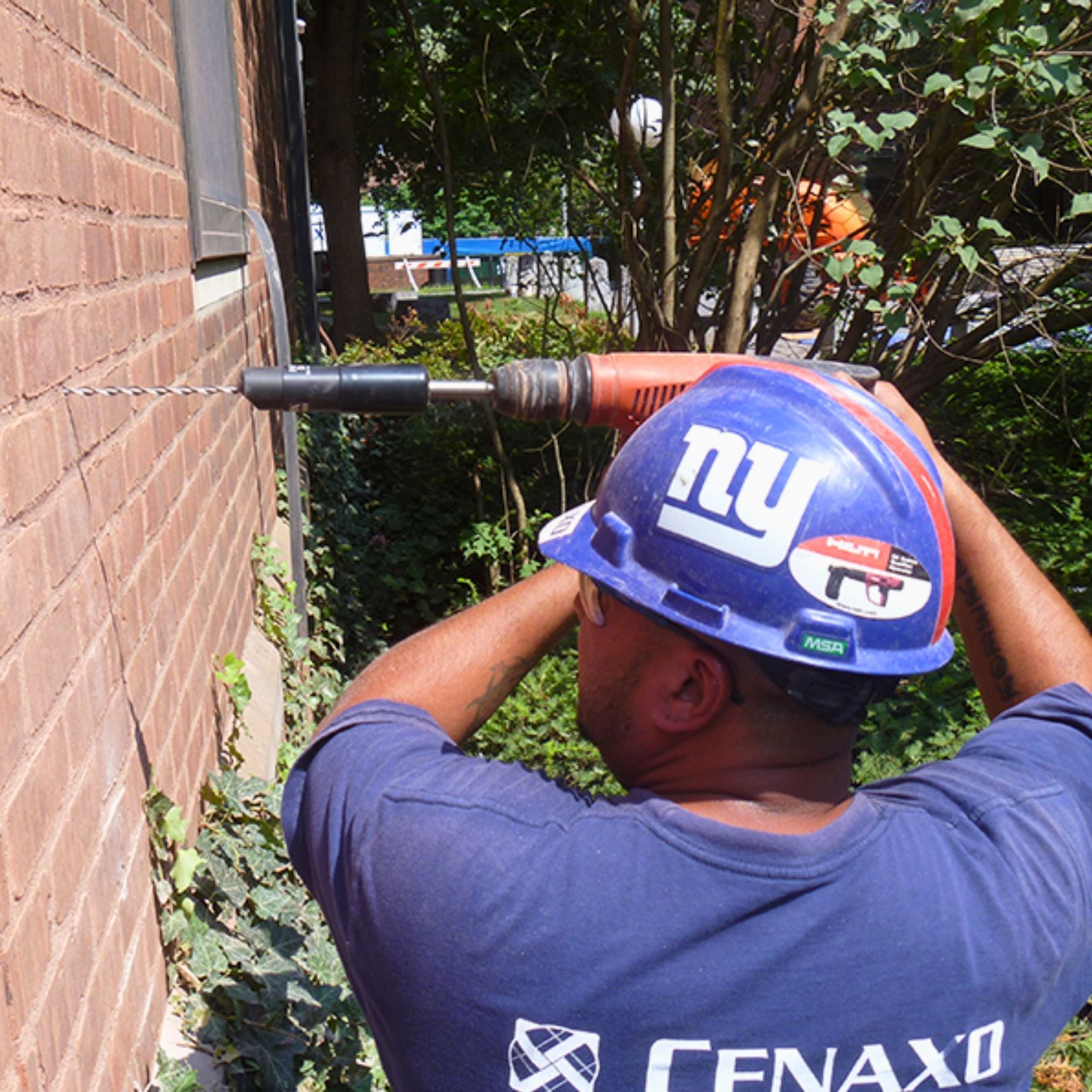 Cenaxo craftsman preparing historic brick facade for restoration work