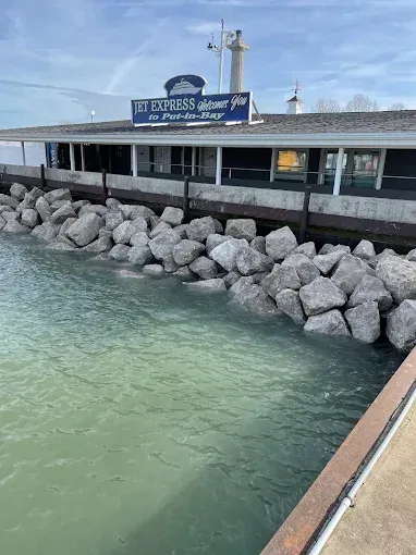A stone-lined shore along a building marked 