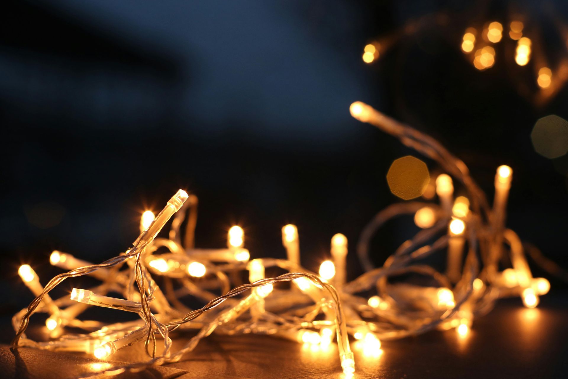 A close up of a string of christmas lights on a table.