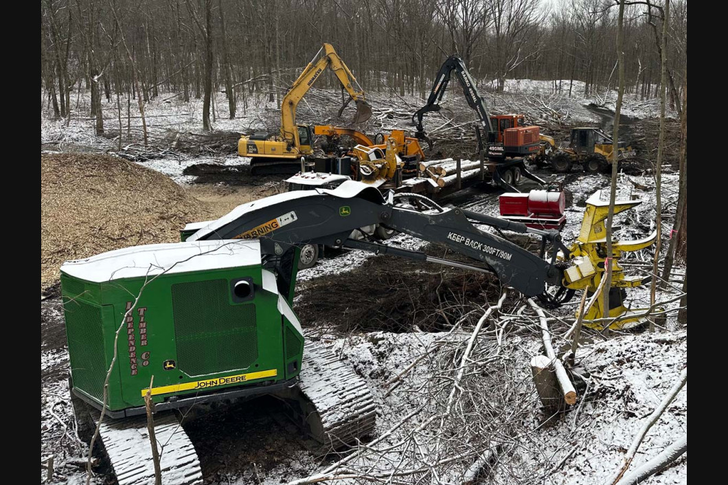 Snowy construction site with excavators and equipment around a dug-out trench