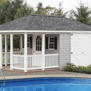 White poolside gazebo with porch railing, gray shingle roof, and attached storage door beside a swimming pool