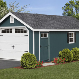 Small teal garage and shed with white trim, white garage door, and shrubs on a green lawn under a blue sky