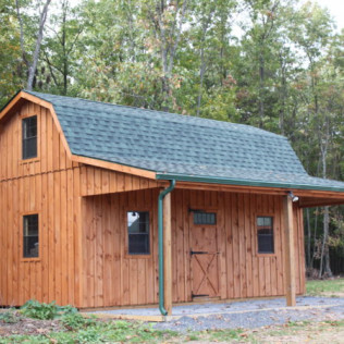 Wooden cabin with blue roof in a wooded area