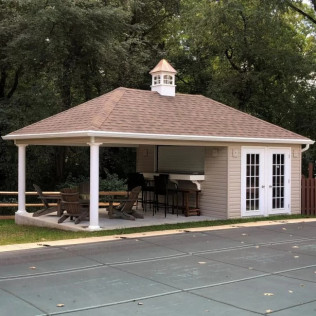 Outdoor gazebo with brown roof, white trim, bar seating, picnic table, and French doors beside a paved court