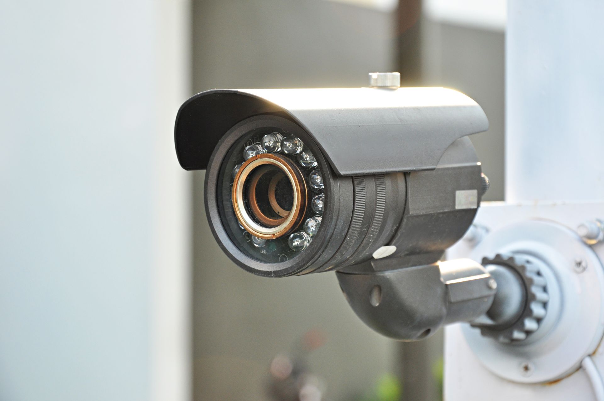Outdoor security camera mounted under a roof for surveillance and property protection. Outdoor security camera mounted under a roof for surveillance and property protection.