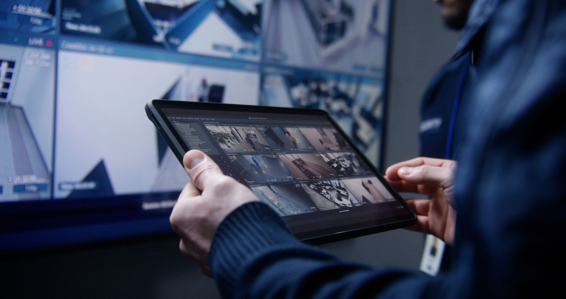 Person reviewing security camera footage on a tablet screen.