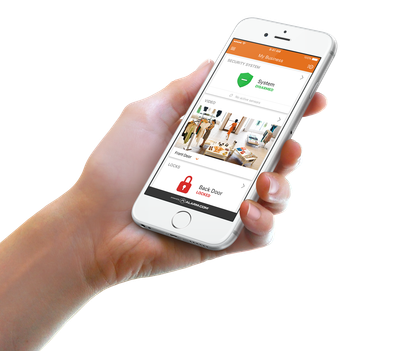 A hand holding a smartphone displaying a security app interface with a green shield icon and live camera feeds.