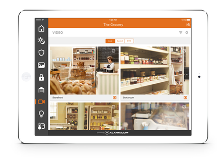 A tablet showing a security camera app, displaying live feeds of a shop interior.
