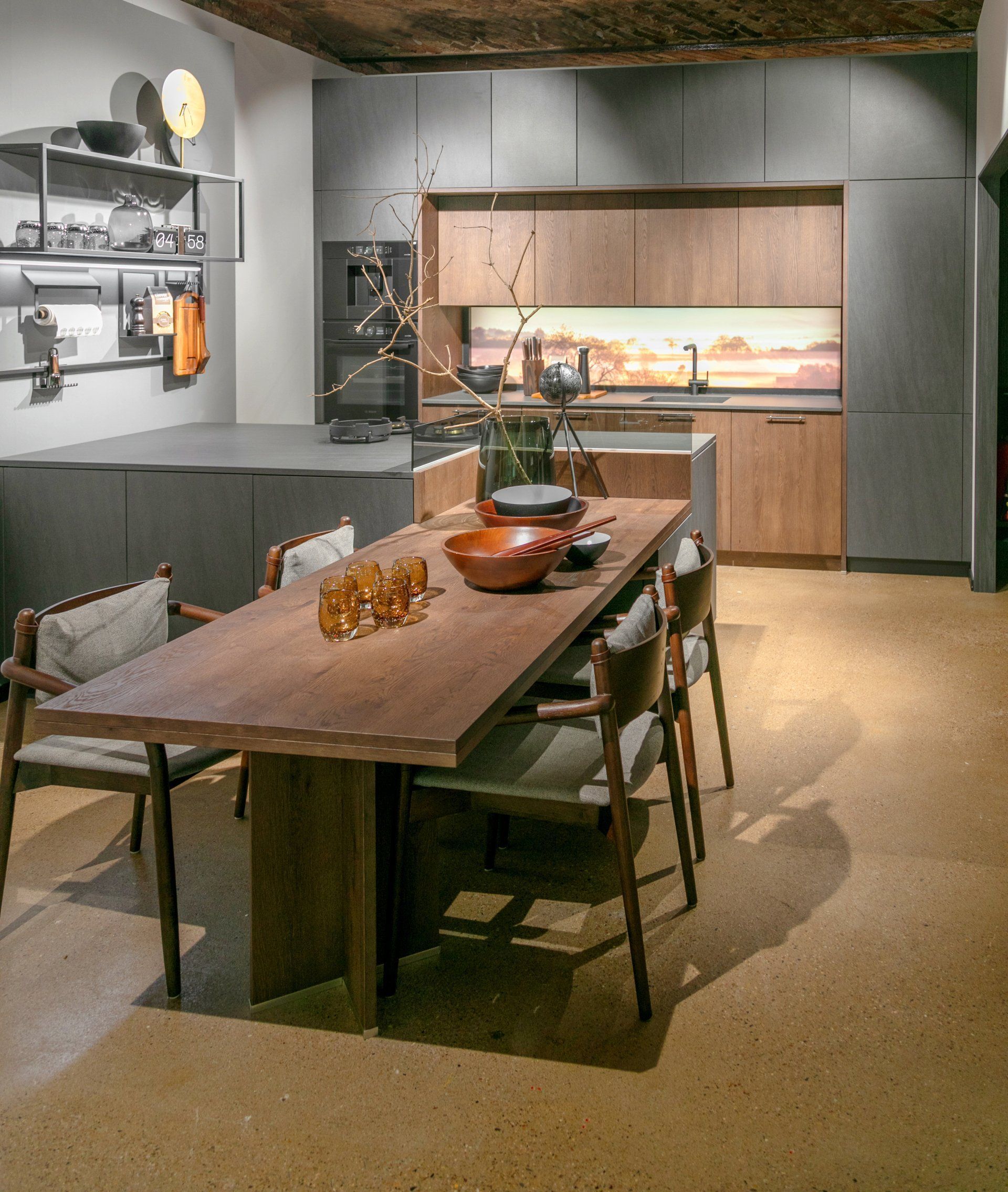 A kitchen with a large wooden table and chairs