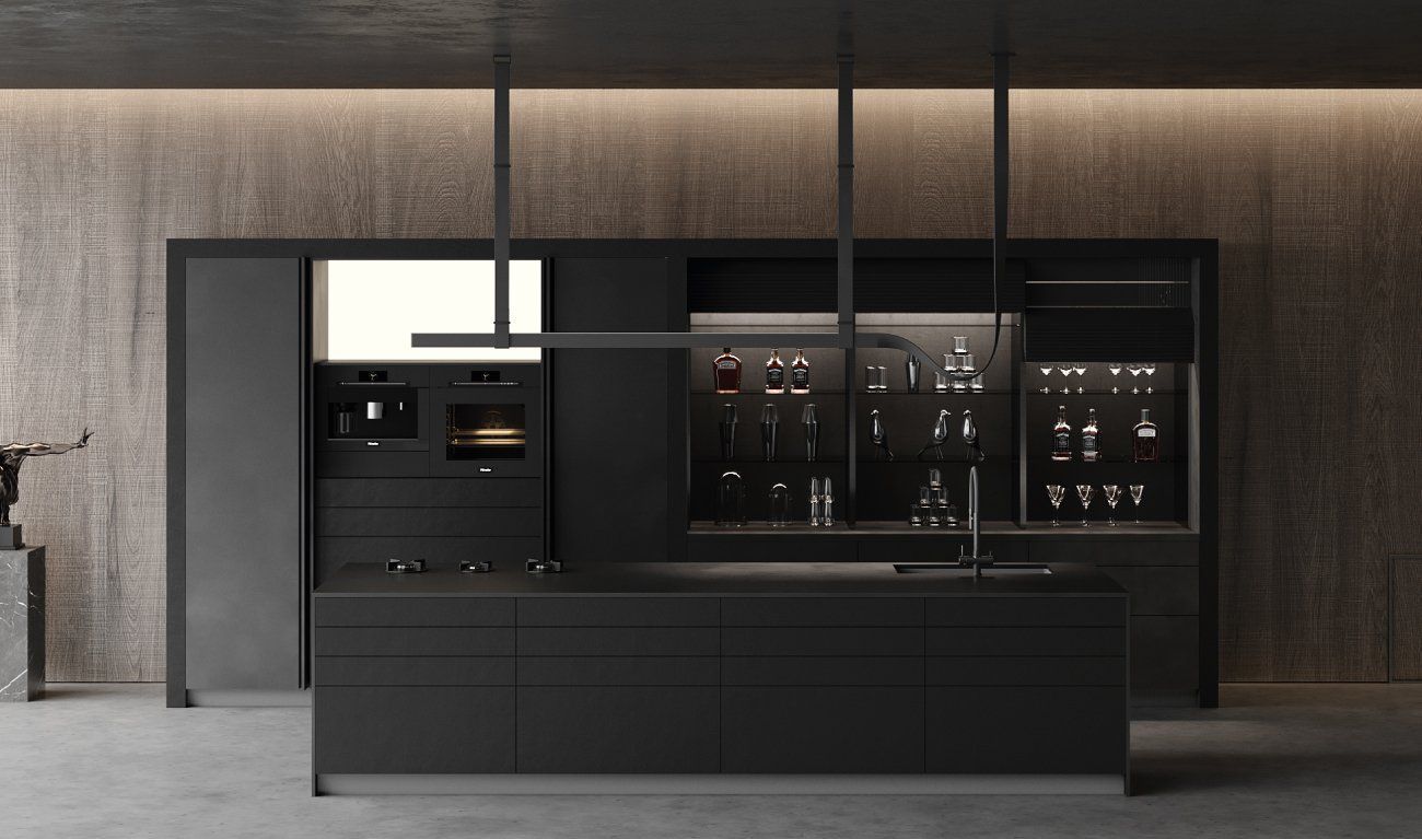 A kitchen with black cabinets and a large island in the middle.