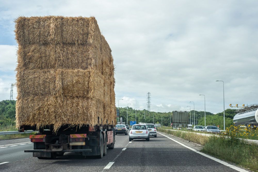 Truck Transporting Stacked Hay Bales on A Highway — Haigh Truck & 4WD Repairs In Orange, NSW