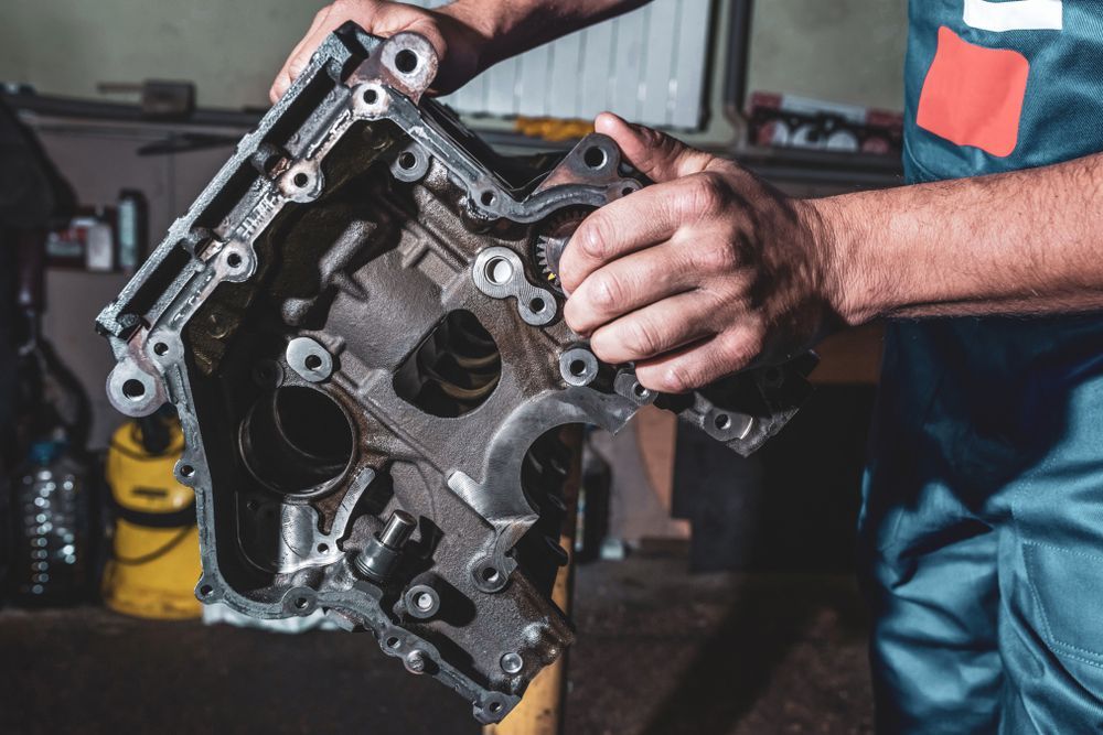 Mechanic Holding an Engine Component in A Repair Shop — Haigh Truck & 4WD Repairs In Orange, NSW