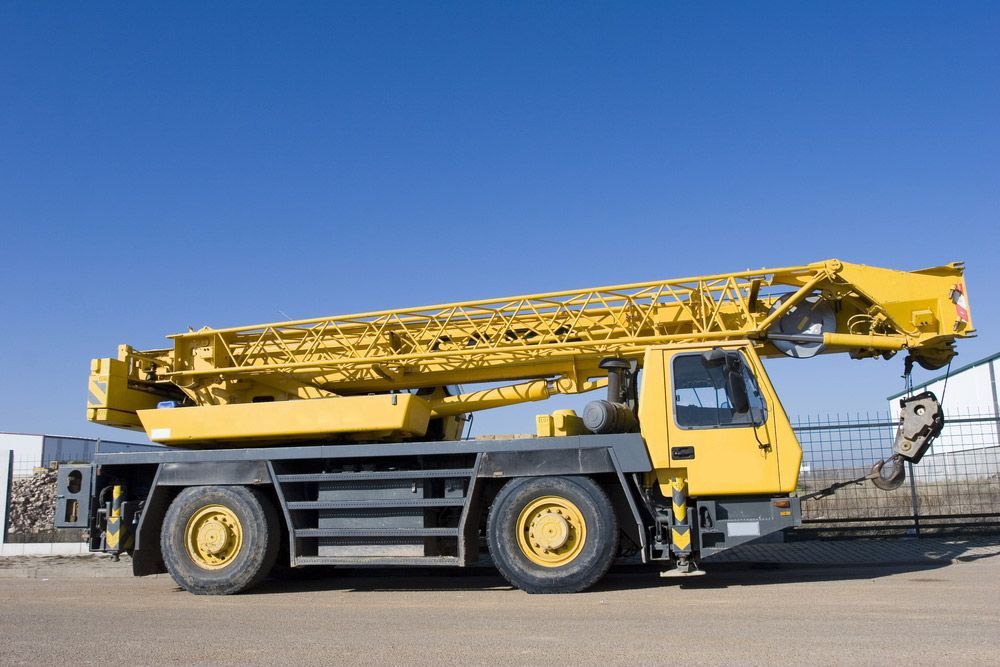 Yellow Mobile Crane Against a Bright Blue Sky — Haigh Truck & 4WD Repairs In Orange, NSW
