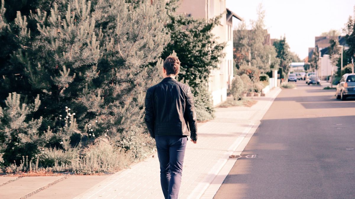 man walking on a sidewalk