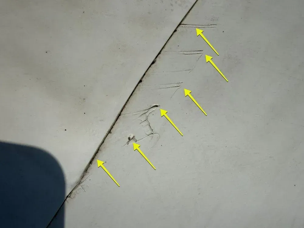 Arrows marking cuts in a white membrane flat roof, Mt. Adams, Cincinnati